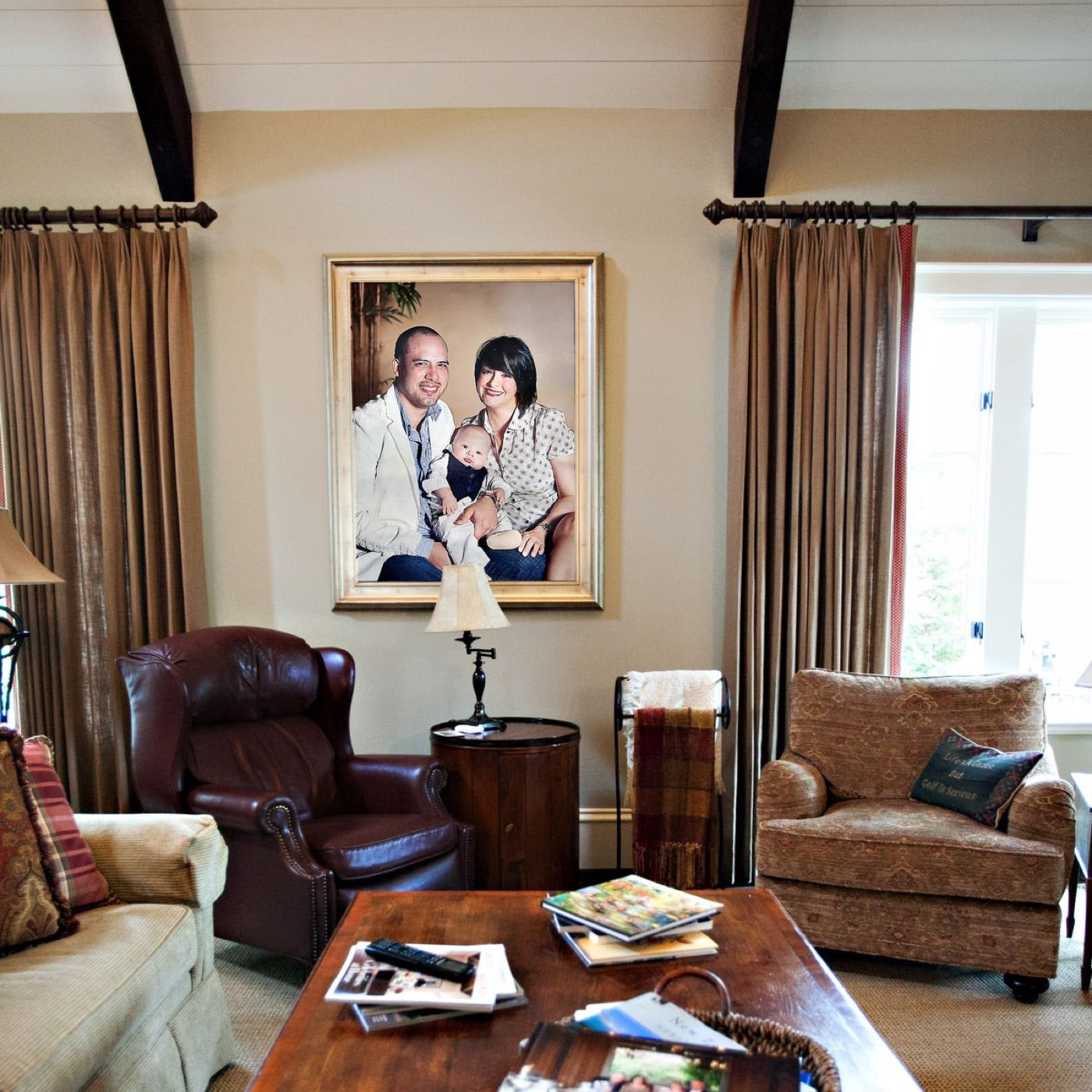 Framed family portrait displayed above living room furniture