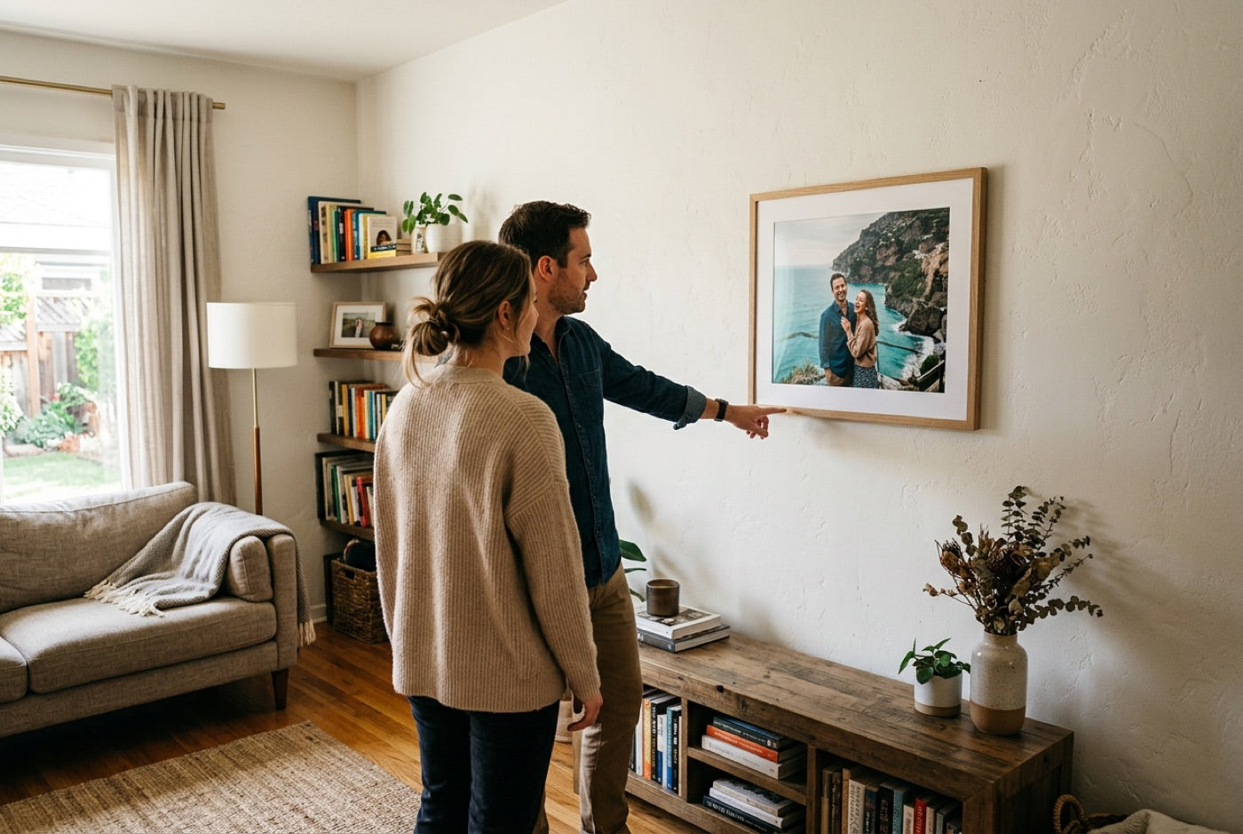 Couple admiring a framed photo hung at a comfortable viewing height